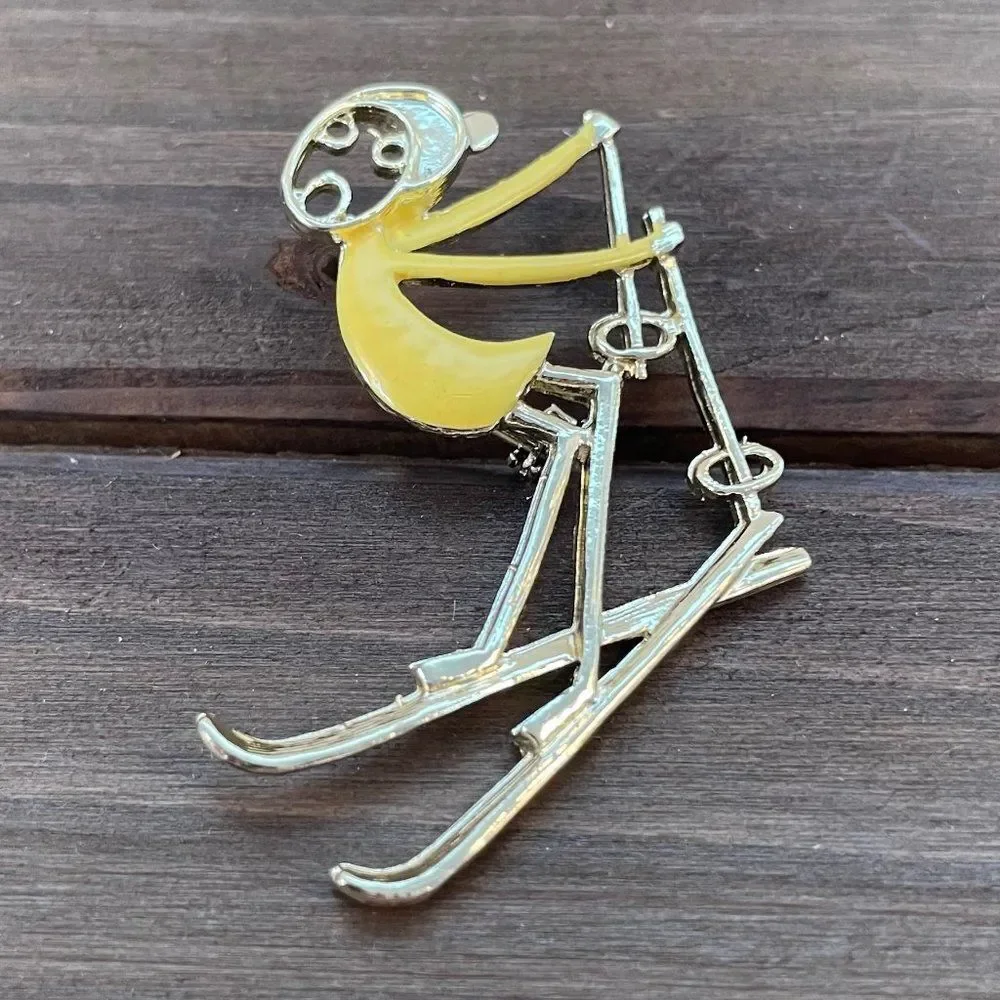 Vintage Ski Pin Falling Skier Gold Tone Yellow Enamel Cartoon Style R.N. Koch